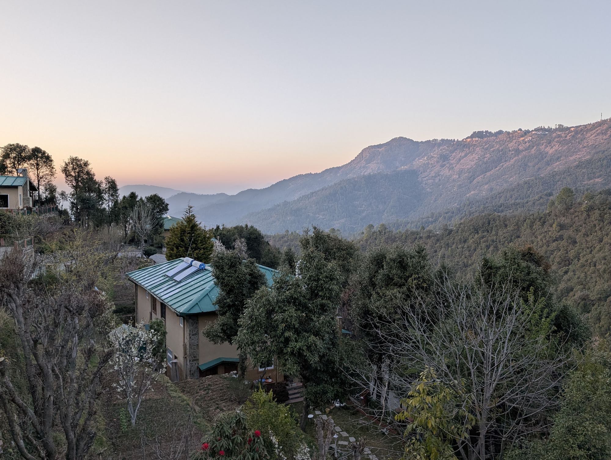 The house at dusk, seen across the valley