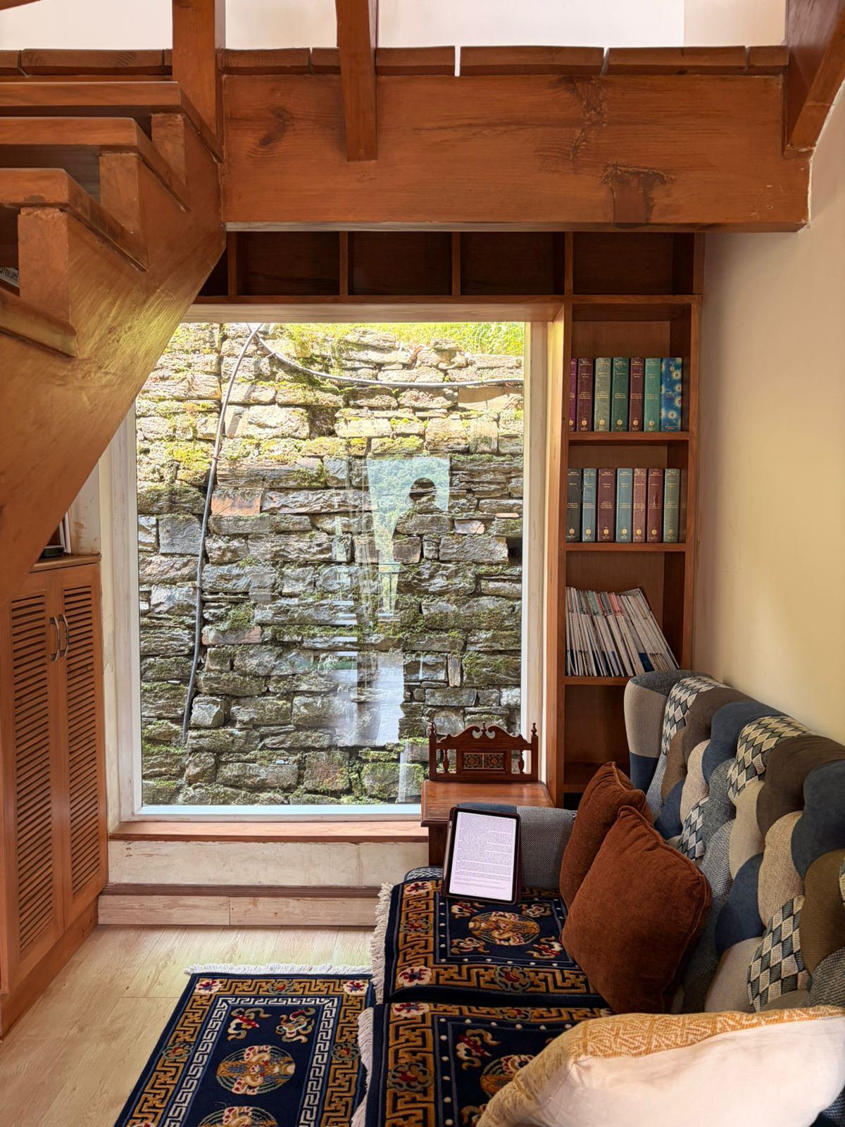 A cozy library nook with a stone wall view